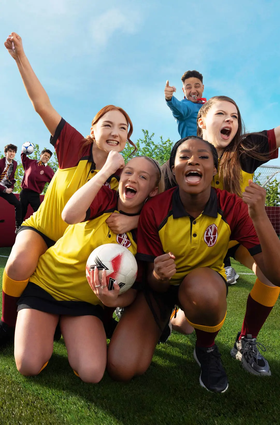 Group of young football players celebrating