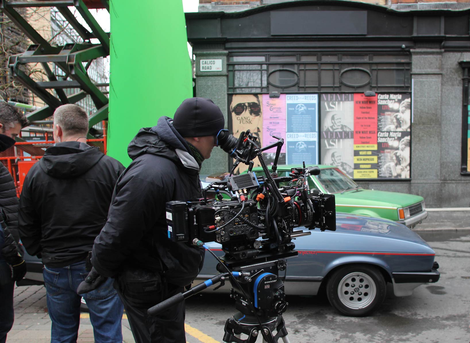Film crew operating camera equipment outdoors